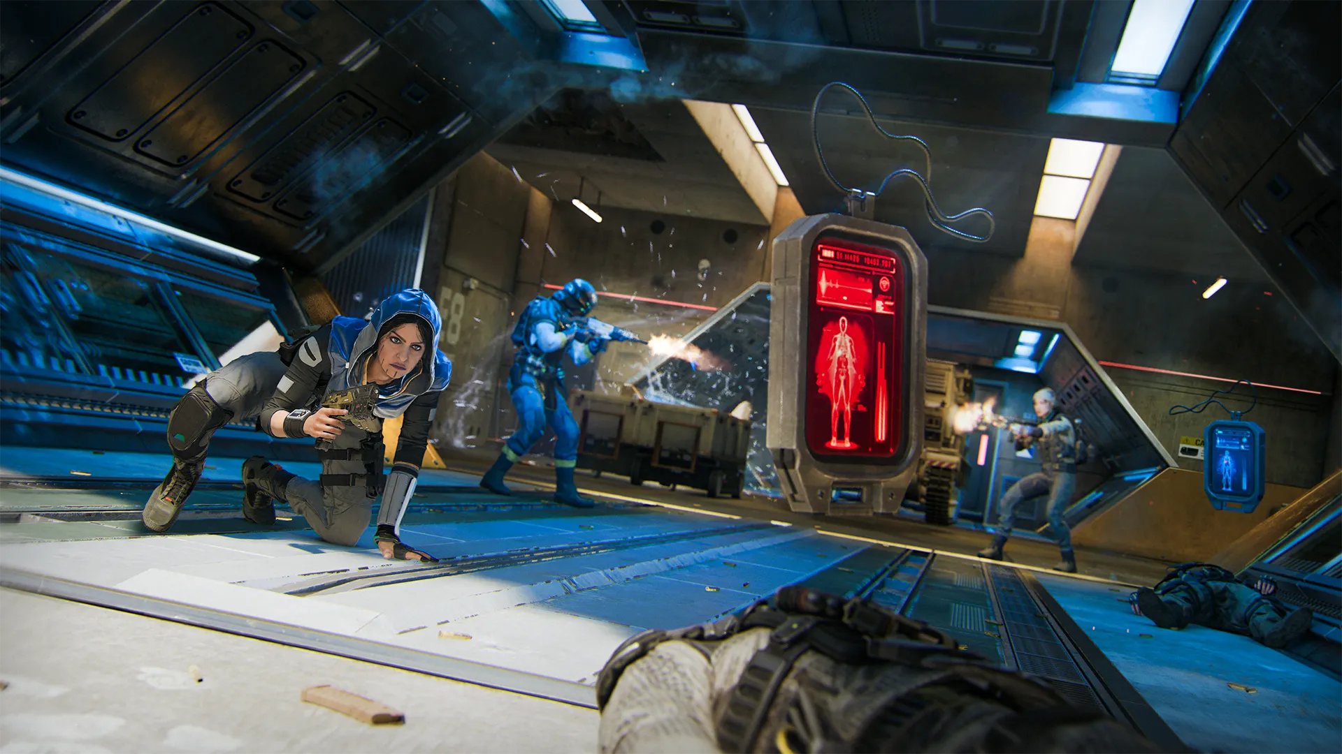 Inside a futuristic corridor, a soldier (Zaveri) in a blue hoodie slides into the foreground, pistol drawn. Behind her, a shootout unfolds between armored fighters, with bullets shattering glass around a red medical scanner displaying human anatomy.