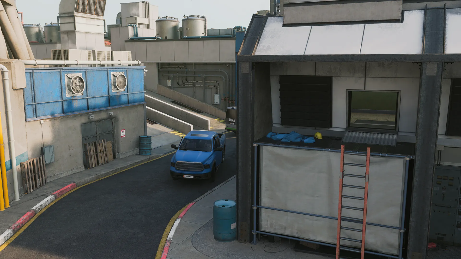 A narrow service road curves between industrial buildings, with a blue pickup truck parked near barrels, ladders, and ventilation units. Pipes, vents, and utility panels line the walls, reinforcing the feel of a busy maintenance area.