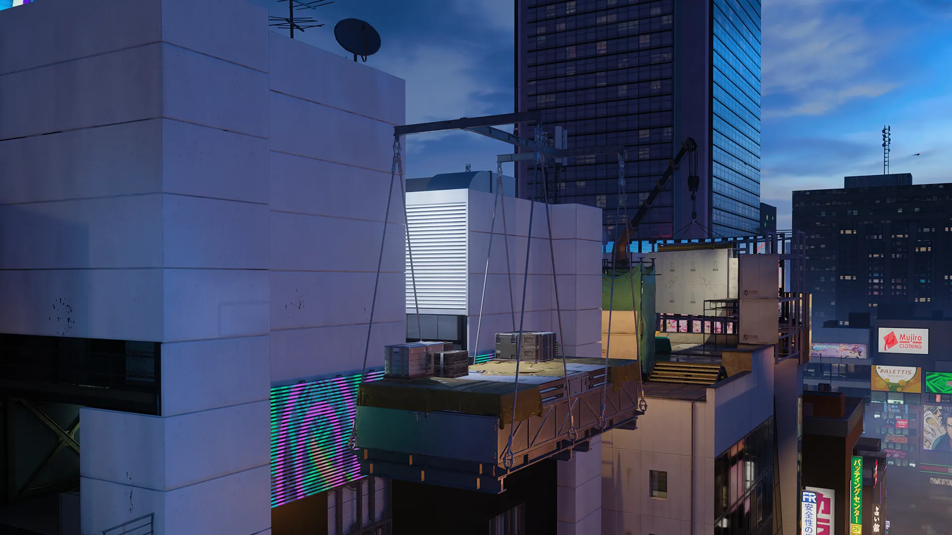 A nighttime rooftop scene shows a suspended maintenance platform hanging between tall buildings, with crates and equipment secured on top. City lights and high-rise windows glow in the background, emphasizing the height and urban setting.