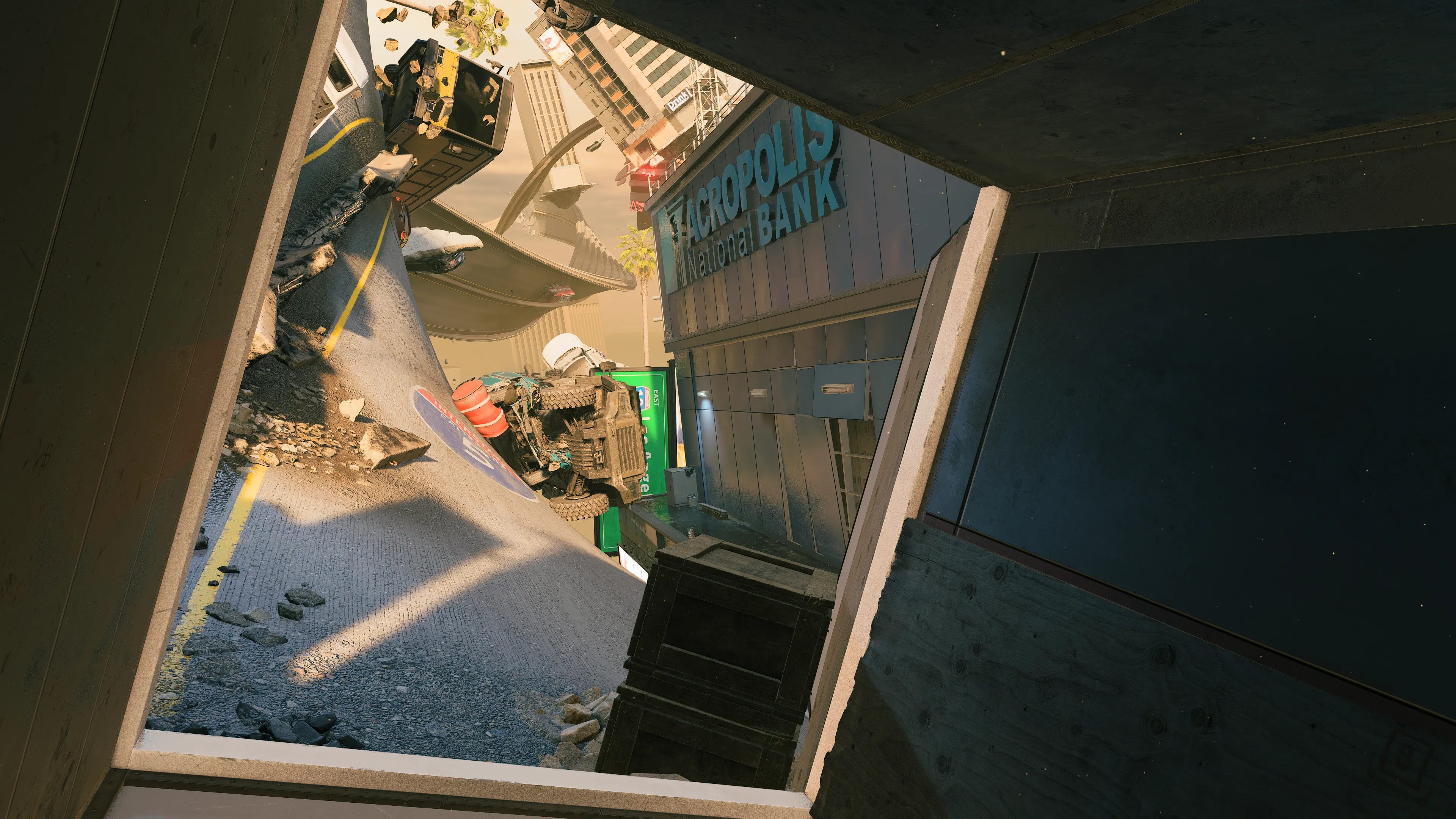 View from inside a shattered structure looking out onto a tilted roadway with wrecked vehicles and the “Acropolis National Bank” building beneath twisted freeway ramps.