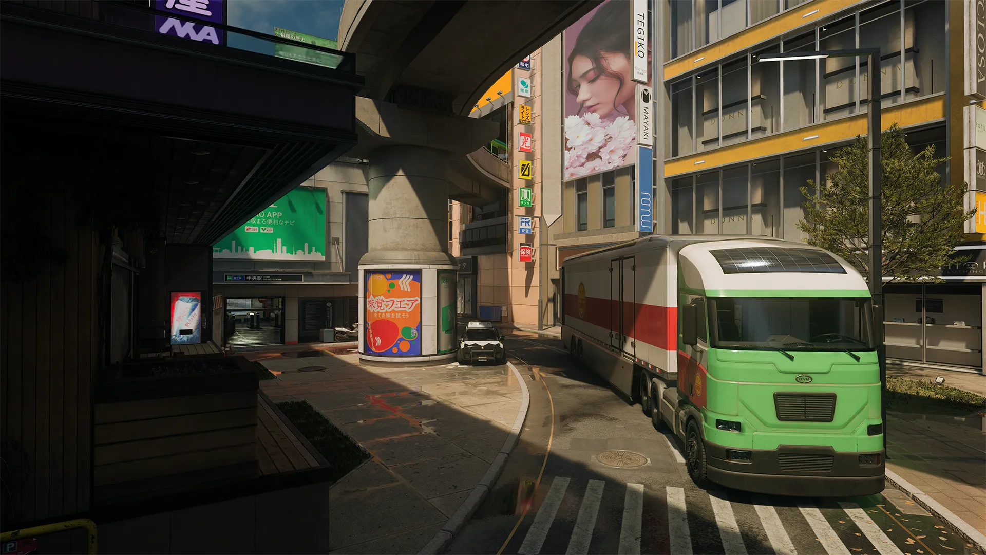 Curved city street under an overpass with a green truck parked near a metro entrance and bright signage.