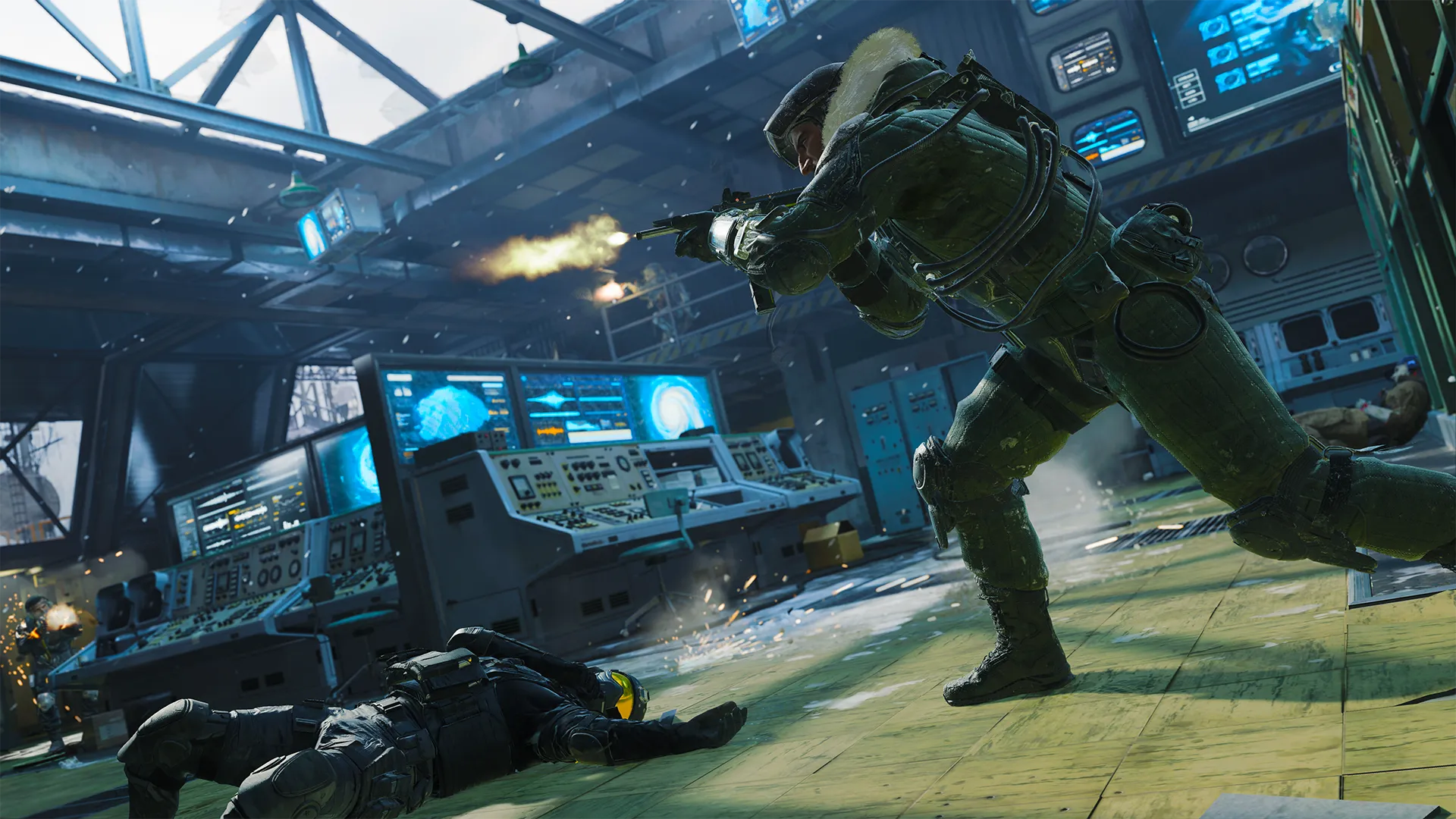 Inside a control room, a soldier fires while another lies on the floor near glowing monitors.