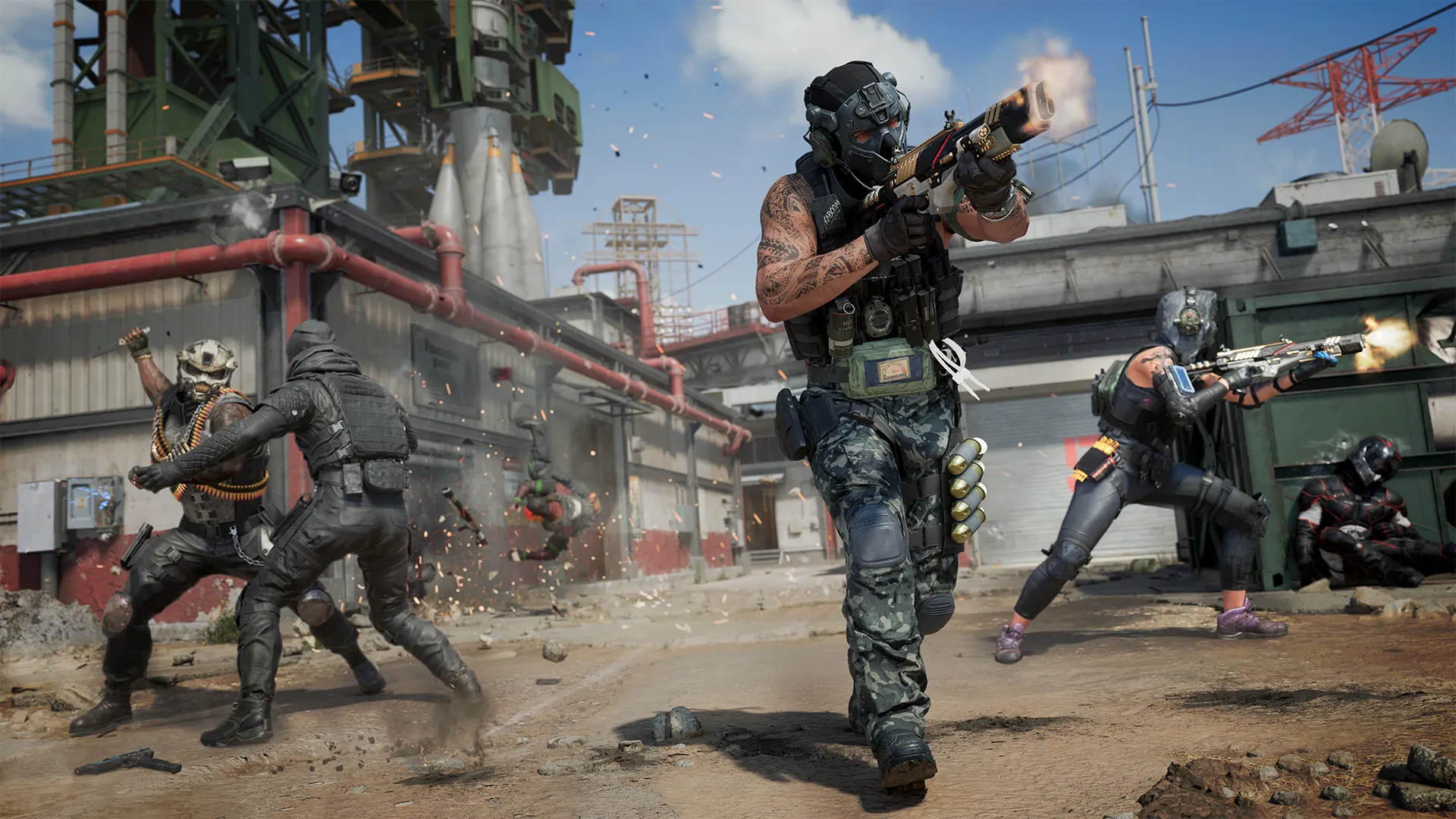 Multiple operators battle across an industrial launch facility, with gunfire, explosions, and close-quarters combat.
