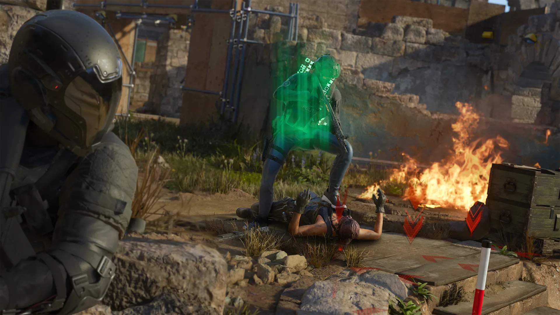 A downed teammate is revived with a green holographic effect while another operator provides cover near burning ruins.