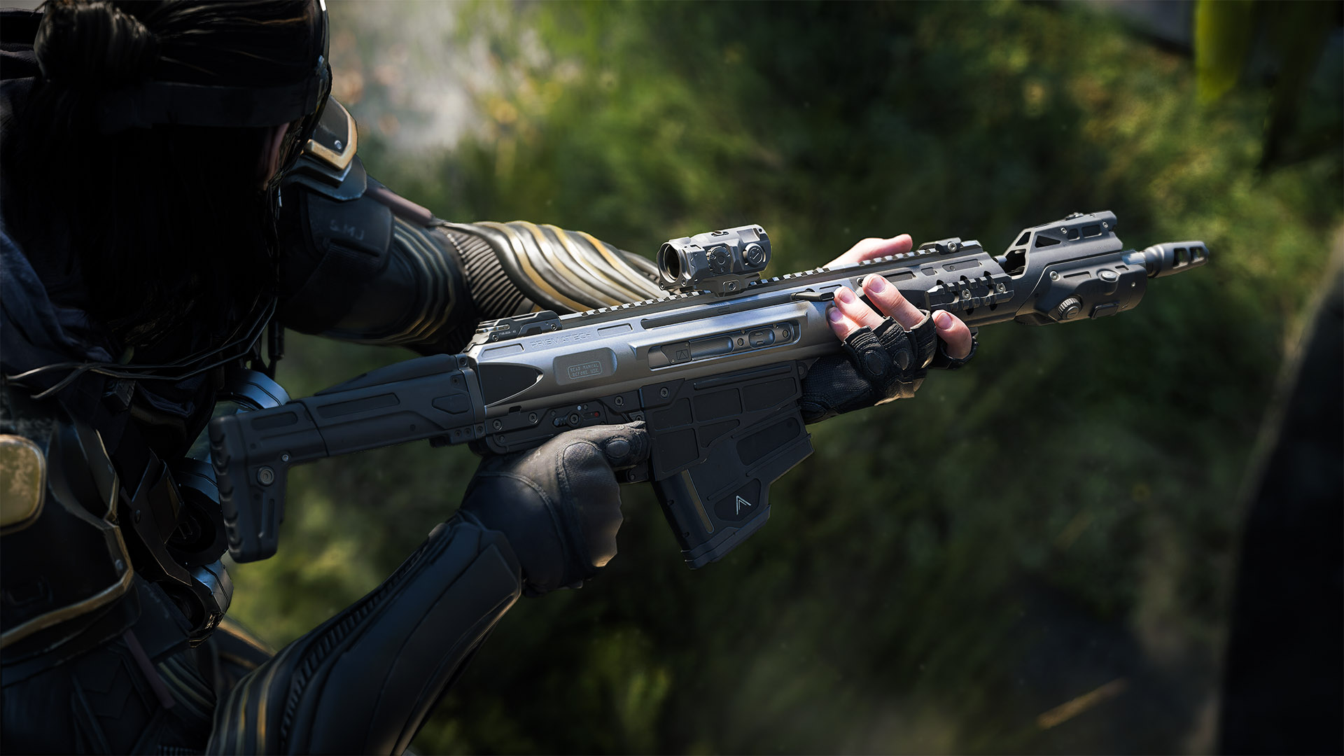 Operator holds a rifle fitted with an optic against a blurred jungle backdrop.