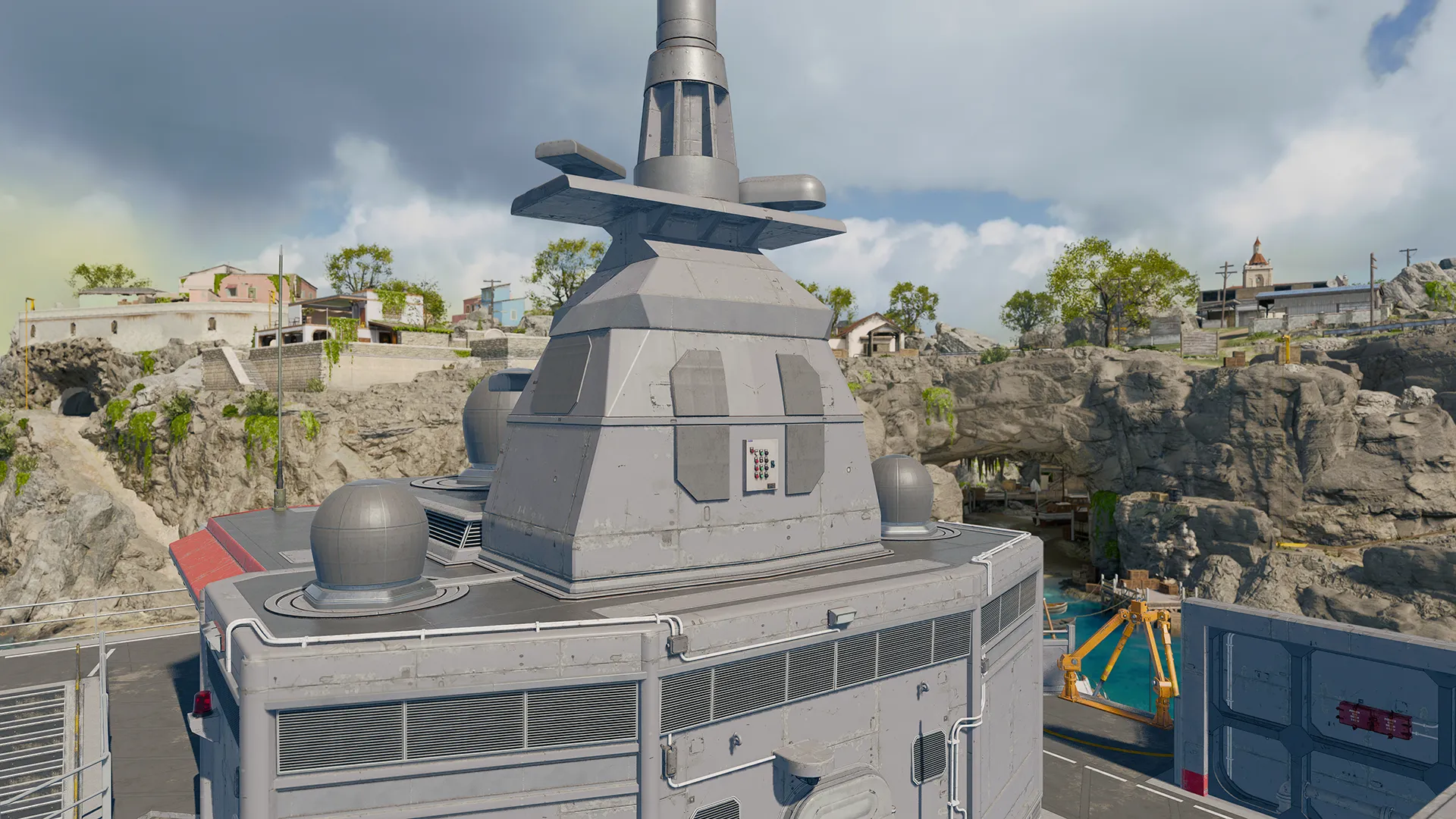 A radar tower mounted on a ship deck beside rocky coastal cliffs.