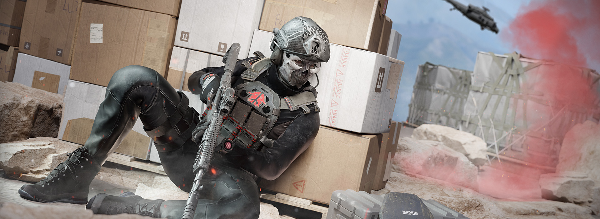 One operator waits behind crates, contemplating capturing a load out crate. A helicopter patrols in the background.