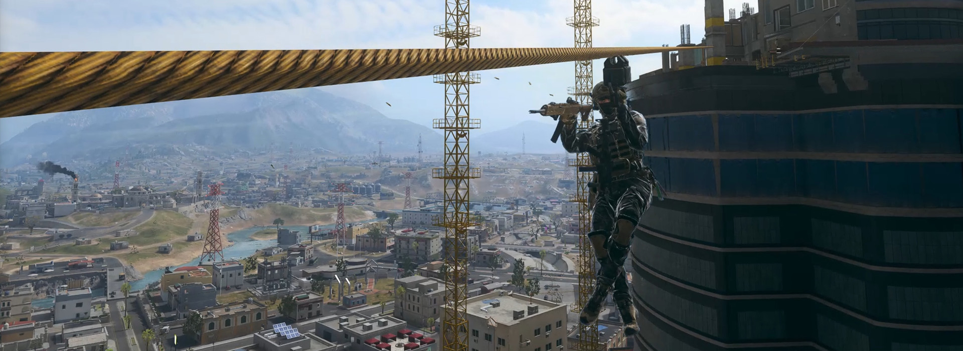 An Operator traveling across a vertical zipline high above the city streets.